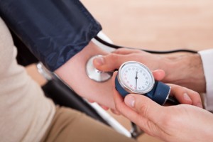 Doctor checking blood pressure